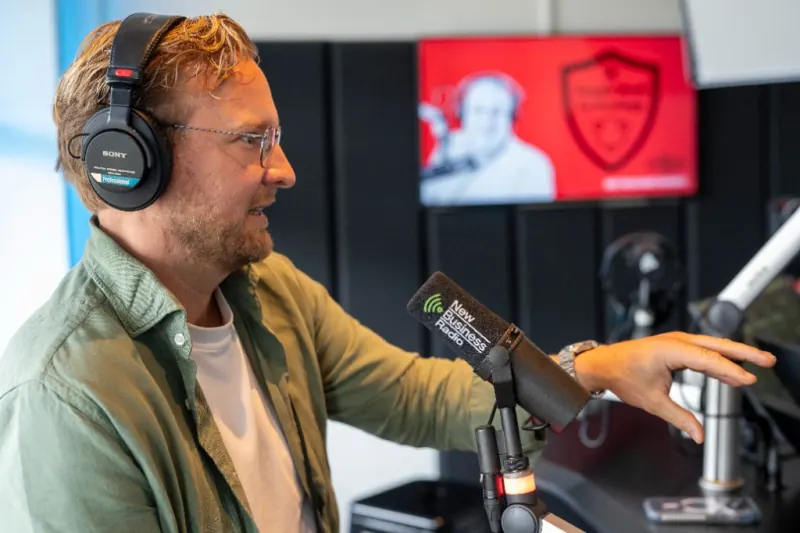 Stefan Sprenkels of Q-Feeds speaking into a New Business Radio microphone.